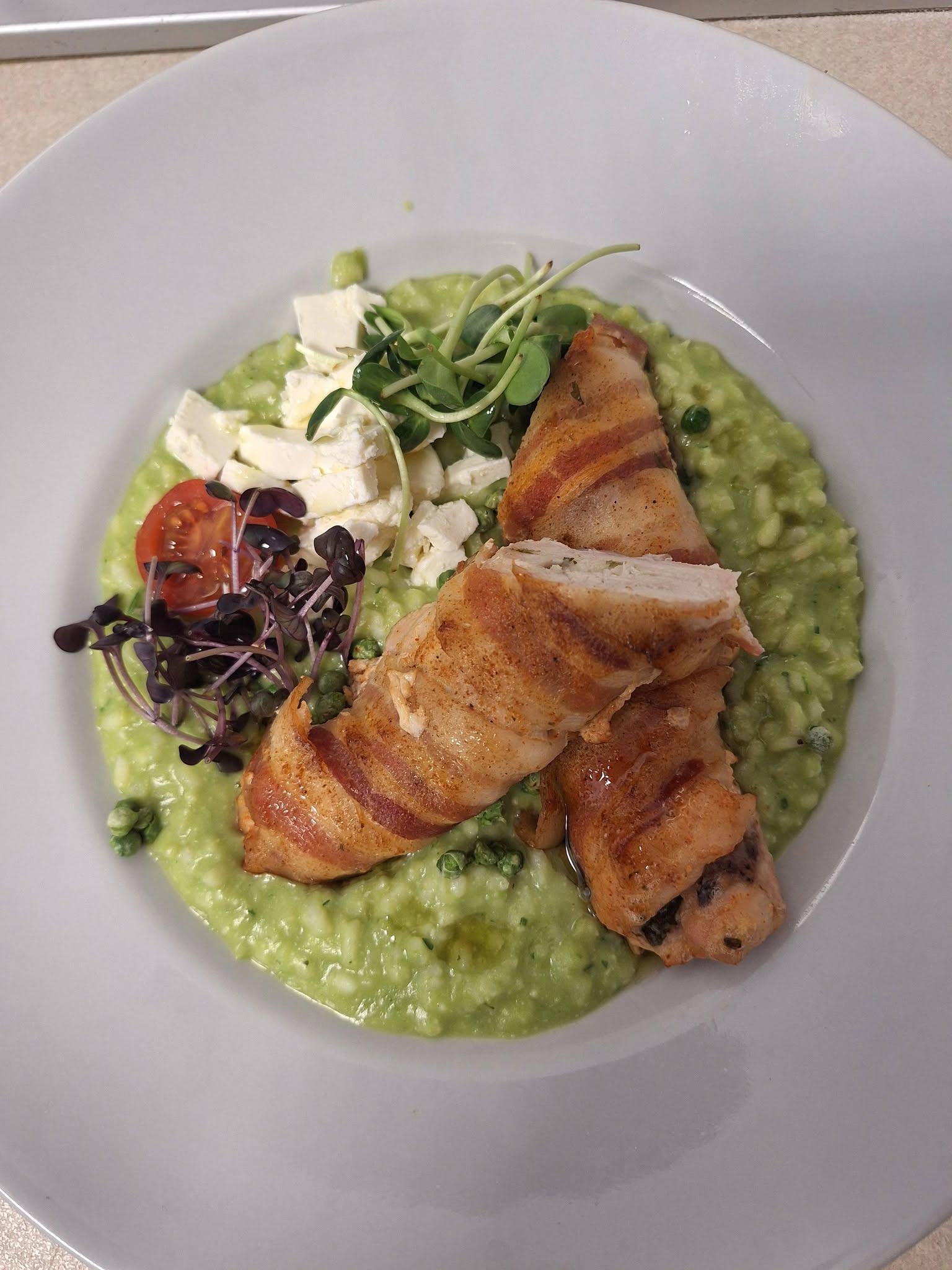 Bacon-wrapped chicken breast with green pea risotto