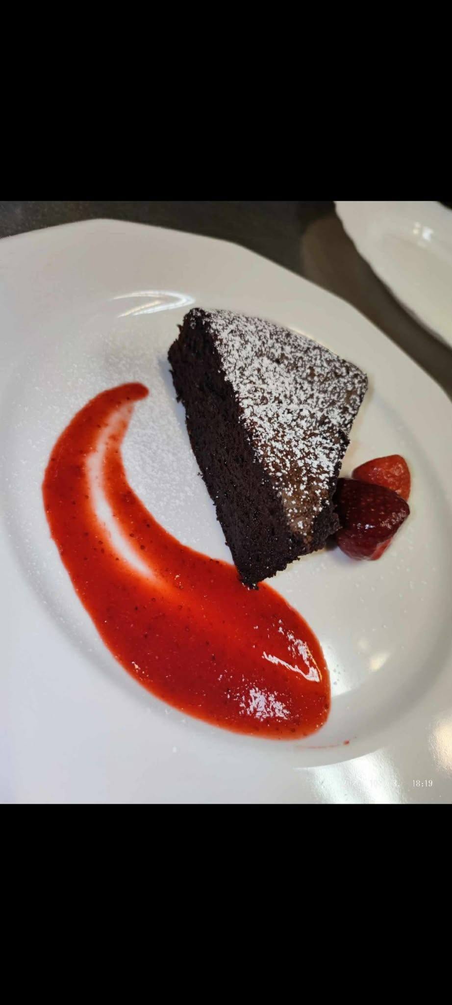Chocolate cake with fruit sauce